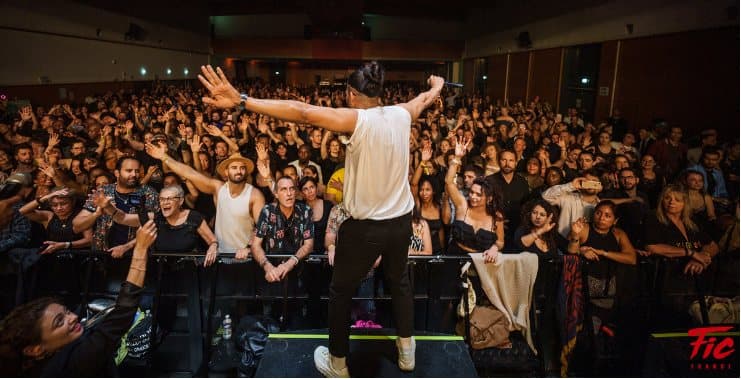 Host on stage in front of a full hall