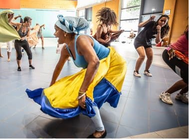 Dancer in a yellow and blue skirt during a folklore class