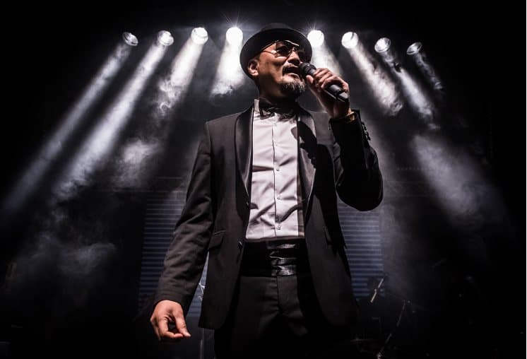 Yoann Henry, founder of the festival, on stage with a microphone